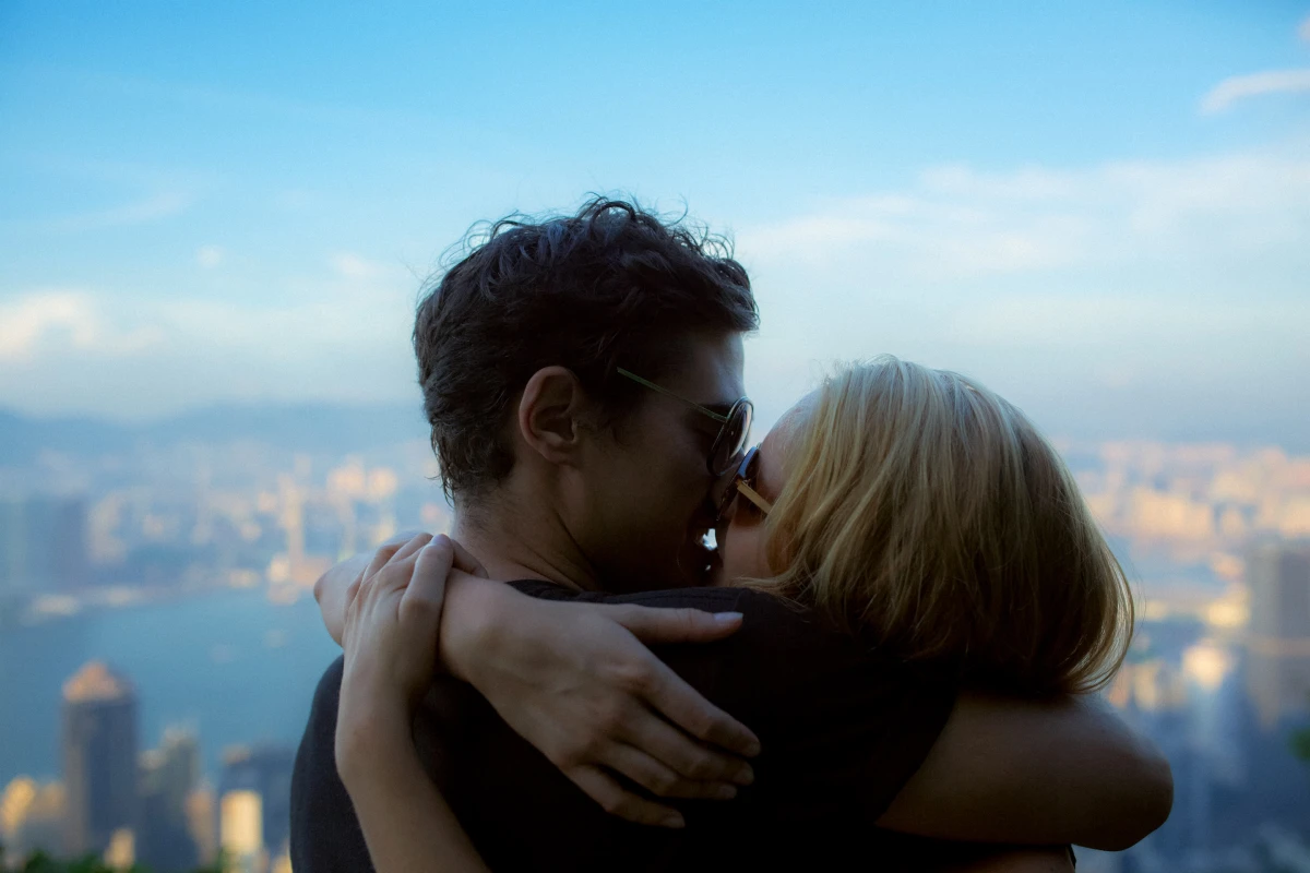 Young couple embracing with Hongkong city view in background for Ray-Ban lifestyle campaign