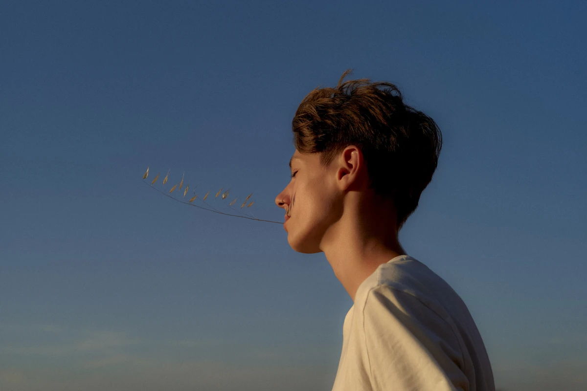 Young man in profile against blue sky for New York Times Well editorial lifestyle portrait