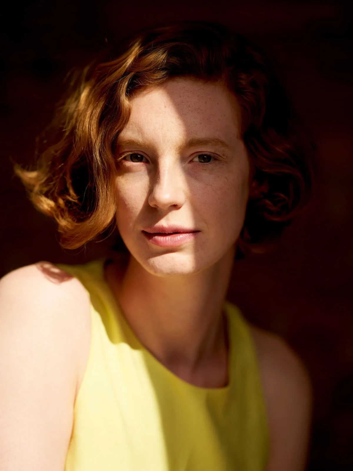 Portrait of Actress Luise Wolfram looking in to the camera in warm sunlight
