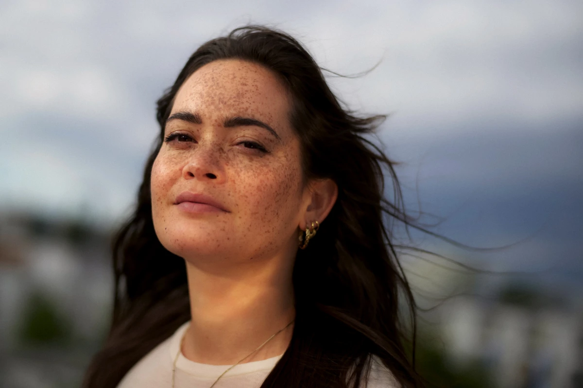 Outdoor portrait of smiling woman in wind for REWE Supermarket commercial lifestyle campaign