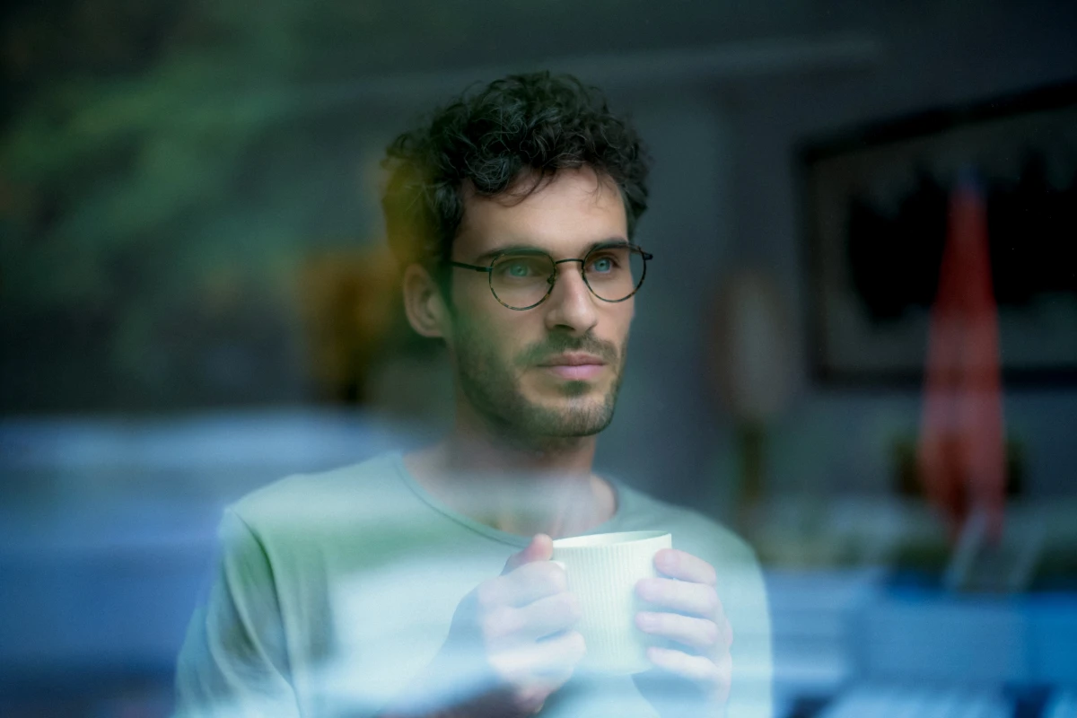 Man with glasses seen through reflective window for Saint-Gobain materials advertising portrait campaign