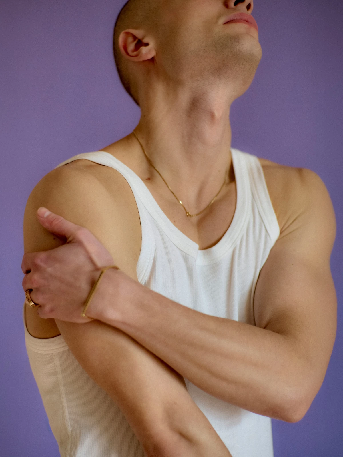 Close crop of man in white tank top against purple background for Bright studio portrait campaign